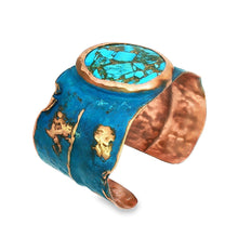 Load image into Gallery viewer, A blue and copper bracelet with a turquoise stone in the center.