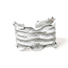 Load image into Gallery viewer, A silver-colored, textured bracelet is shown against a plain white background.