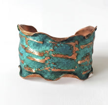 Load image into Gallery viewer, A copper bracelet with a textured, wavy design in shades of green and copper.