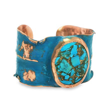 Load image into Gallery viewer, A blue and copper cuff bracelet with a turquoise stone in the center.