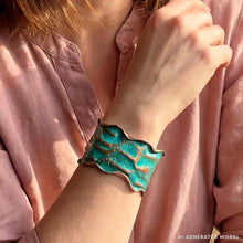 Load image into Gallery viewer, A close-up of a person's wrist wearing a turquoise-colored, textured bracelet.