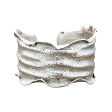 Load image into Gallery viewer, A silver bracelet with a textured, wavy design.

