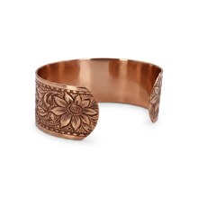 Load image into Gallery viewer, A copper-colored bracelet with an embossed floral design on the surface.

