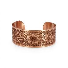 Load image into Gallery viewer, A copper-colored cuff bracelet with an intricate floral design.
