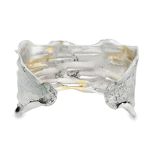 Load image into Gallery viewer, A silver cuff bracelet with a unique, textured design.
