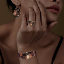 Load image into Gallery viewer, A close-up of a woman&#39;s face, showcasing her hand adorned with a ring and earrings featuring a floral design.
