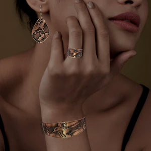 A close-up of a woman&#39;s hand wearing a ring and bracelet, with a pensive expression on her face.