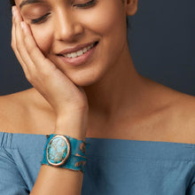 Load image into Gallery viewer, A woman with a smile on her face, wearing a turquoise bracelet, is the focus of the image.
