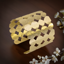 Load image into Gallery viewer, a close up of a gold bracelet on a table
