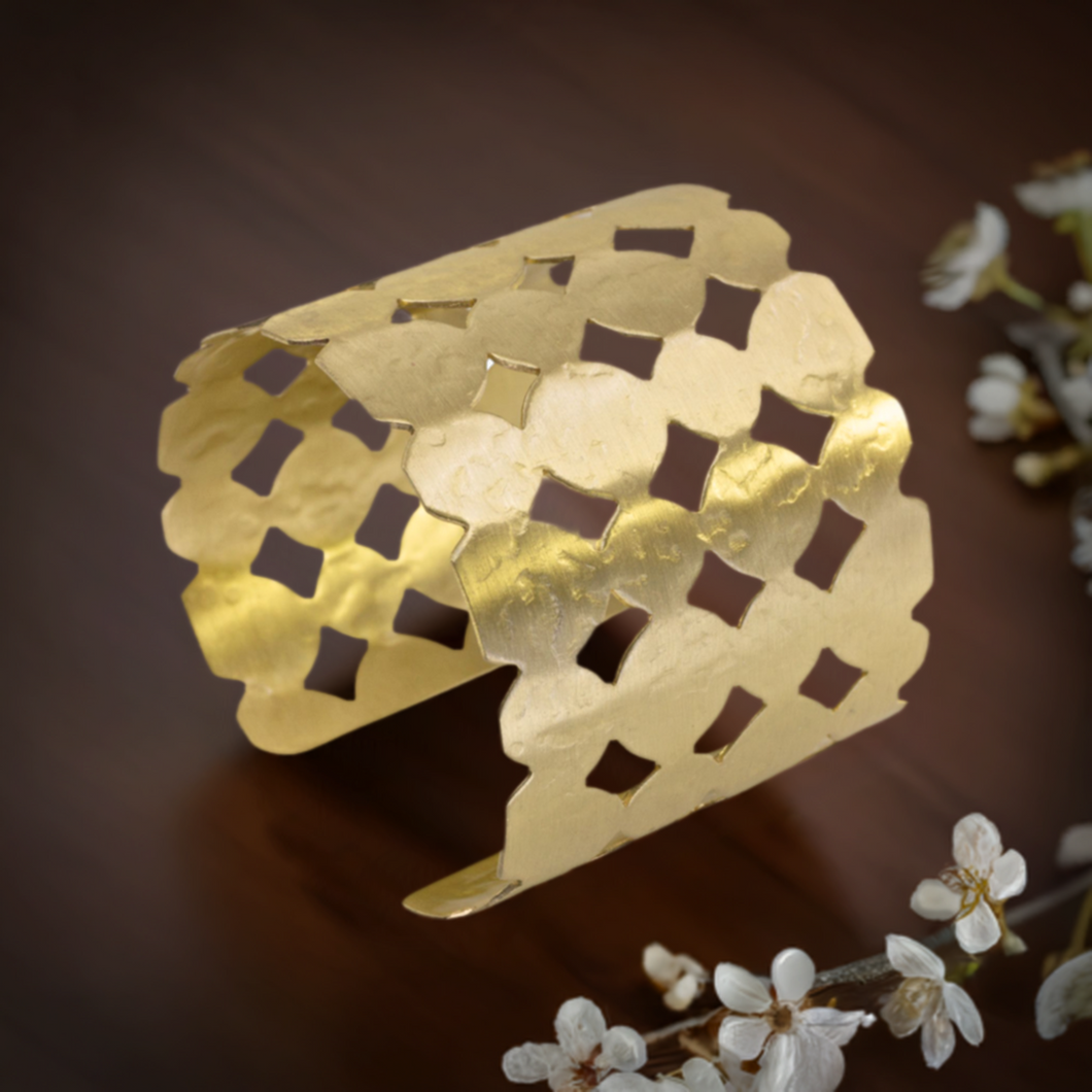 a close up of a gold bracelet on a table